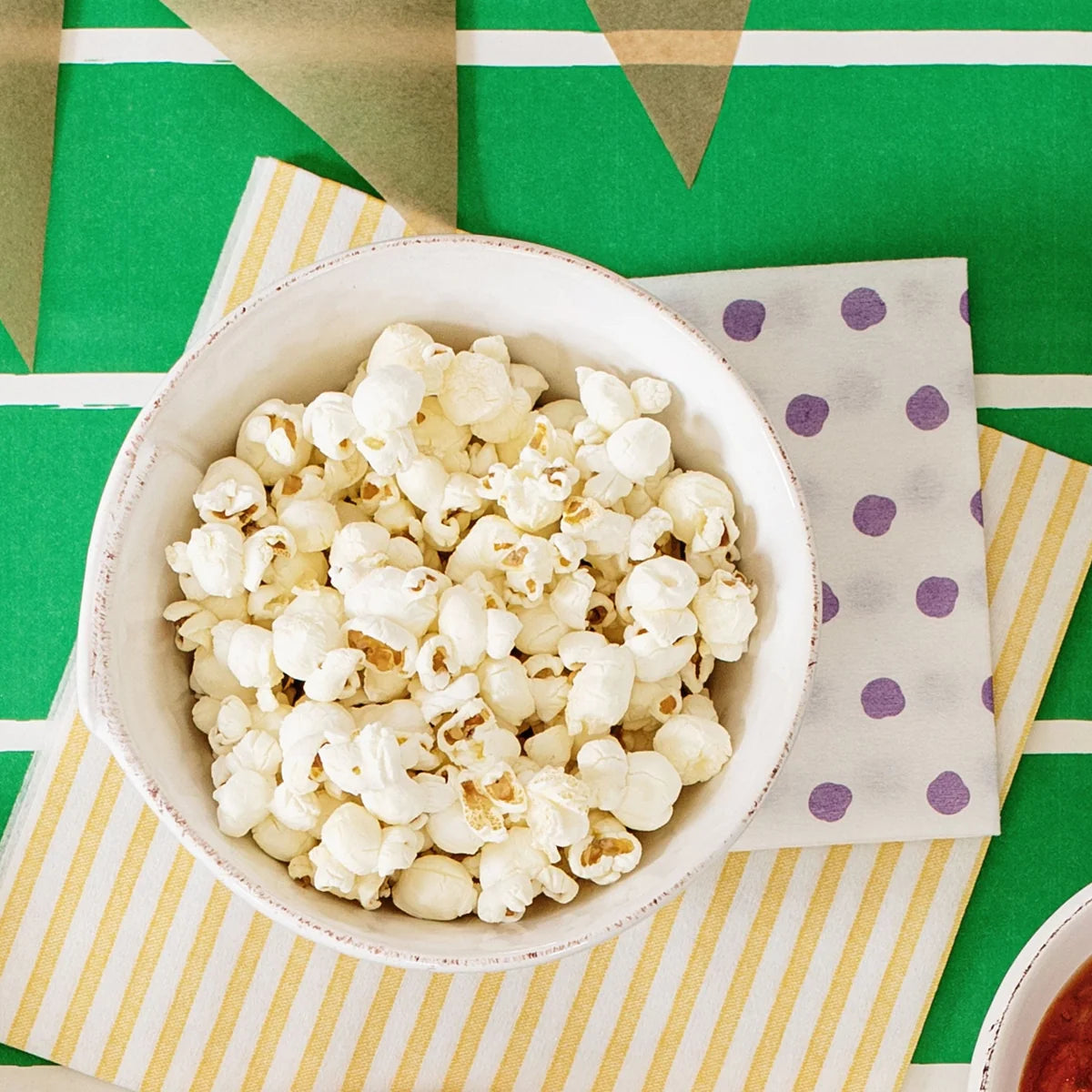 Bowl of popcorn on a colorful tablecloth
