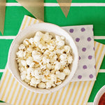 Bowl of popcorn on a colorful tablecloth