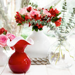 Decorative vases with flowers on a light background