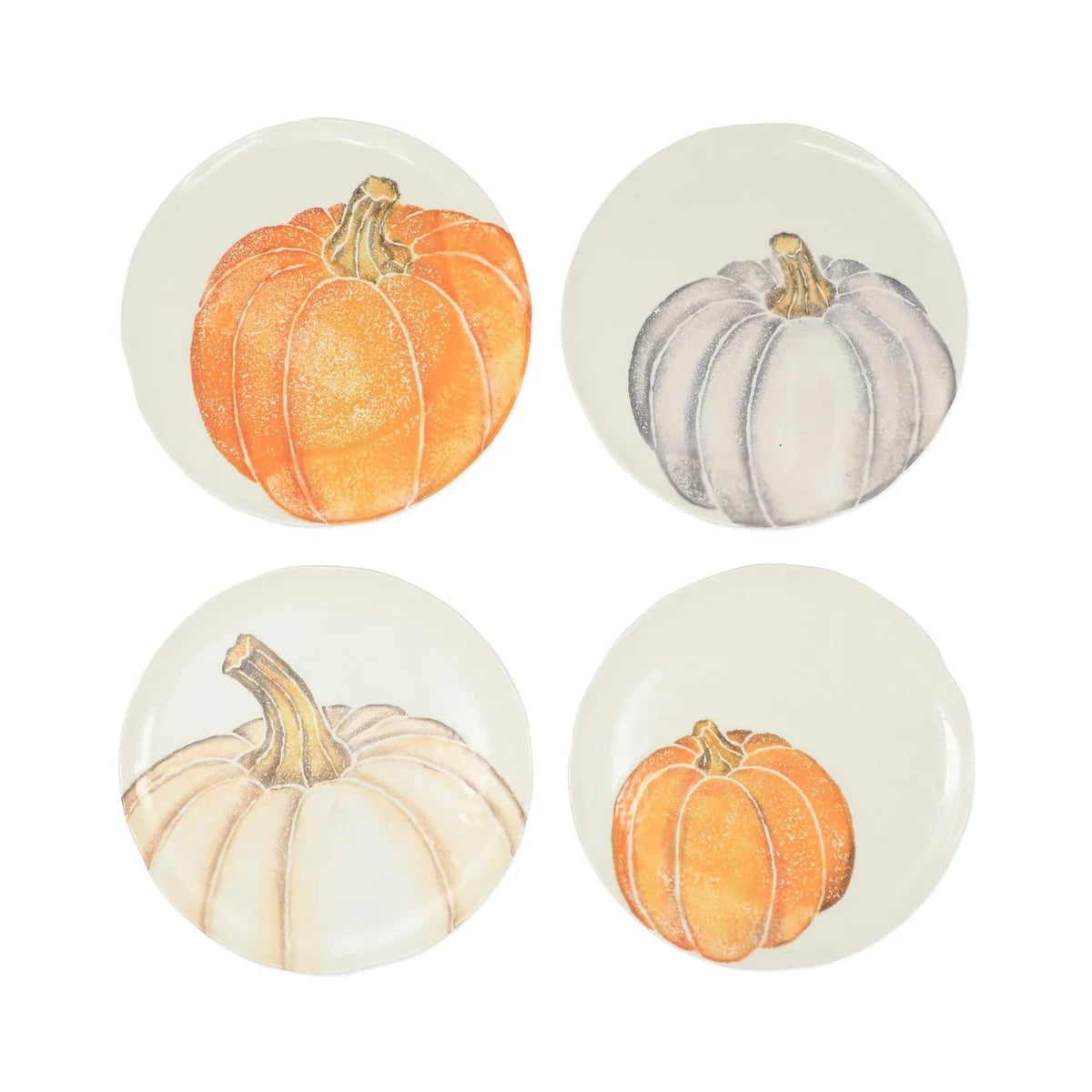 Four ceramic salad plates with pumpkin designs on a white background